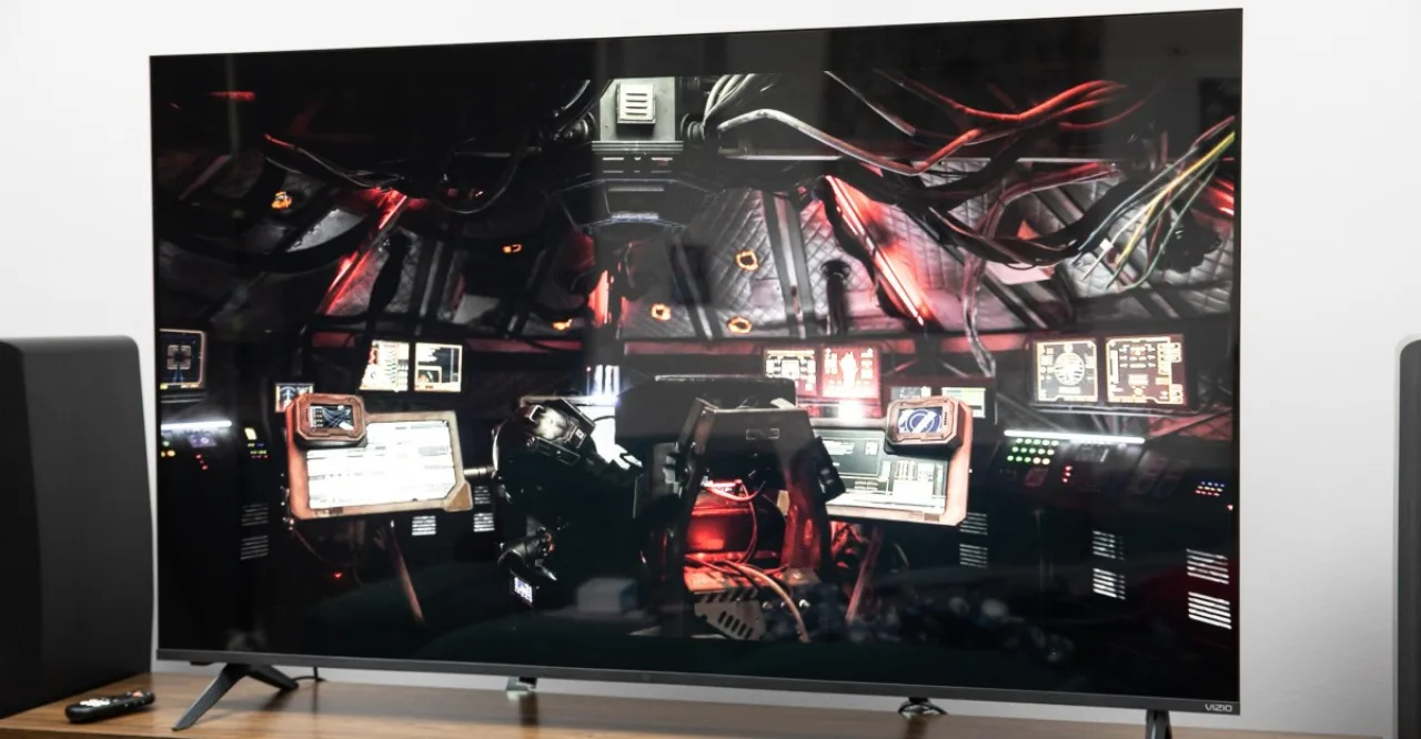 TV Vizio Mini LED Quantum exibida em sala de estar com logotipo do Walmart e etiqueta de preço promocional