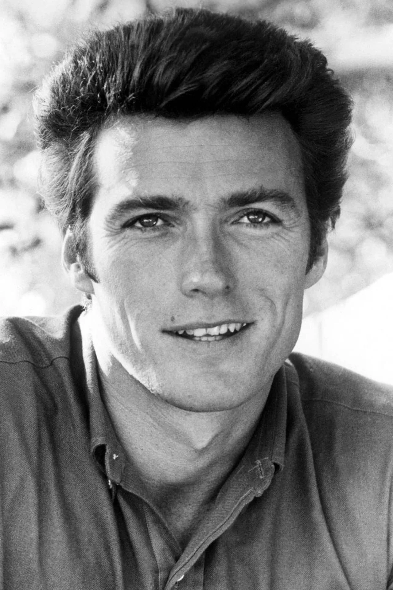 Clint Eastwood caracterizado como Bronco Billy, segurando um laço de cowboy em um cenário de circo vintage