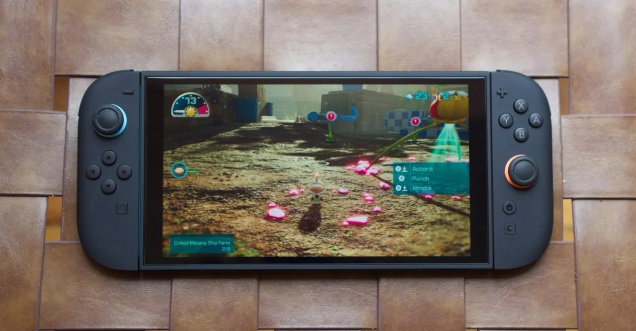 Console Nintendo Switch 2 sobre um tapete de yoga ao lado de halteres e uma garrafa d'água