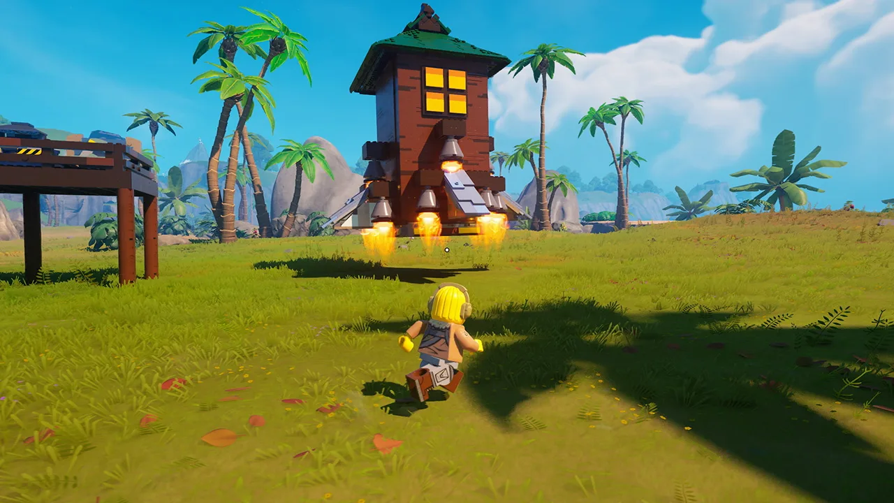 Jovem faz agachamento segurando o controle do PlayStation clássico ao lado de peças LEGO coloridas