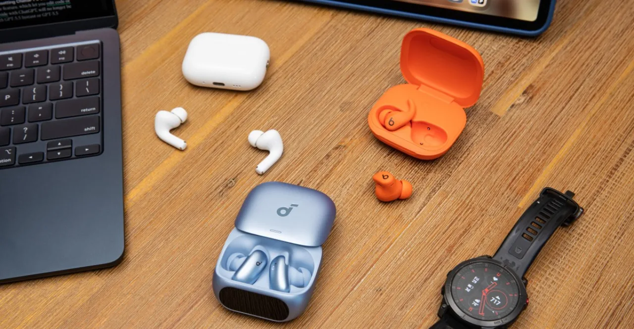 Corredor em pista ao pôr‑sol usando earbuds Sony, Apple e Samsung, com garrafa d'água e smartwatch na mão