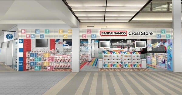 Fachada iluminada da Bandai Namco Cross Store ao lado da G‑BASE, com letreiros e kits de Gunpla no Mall of America