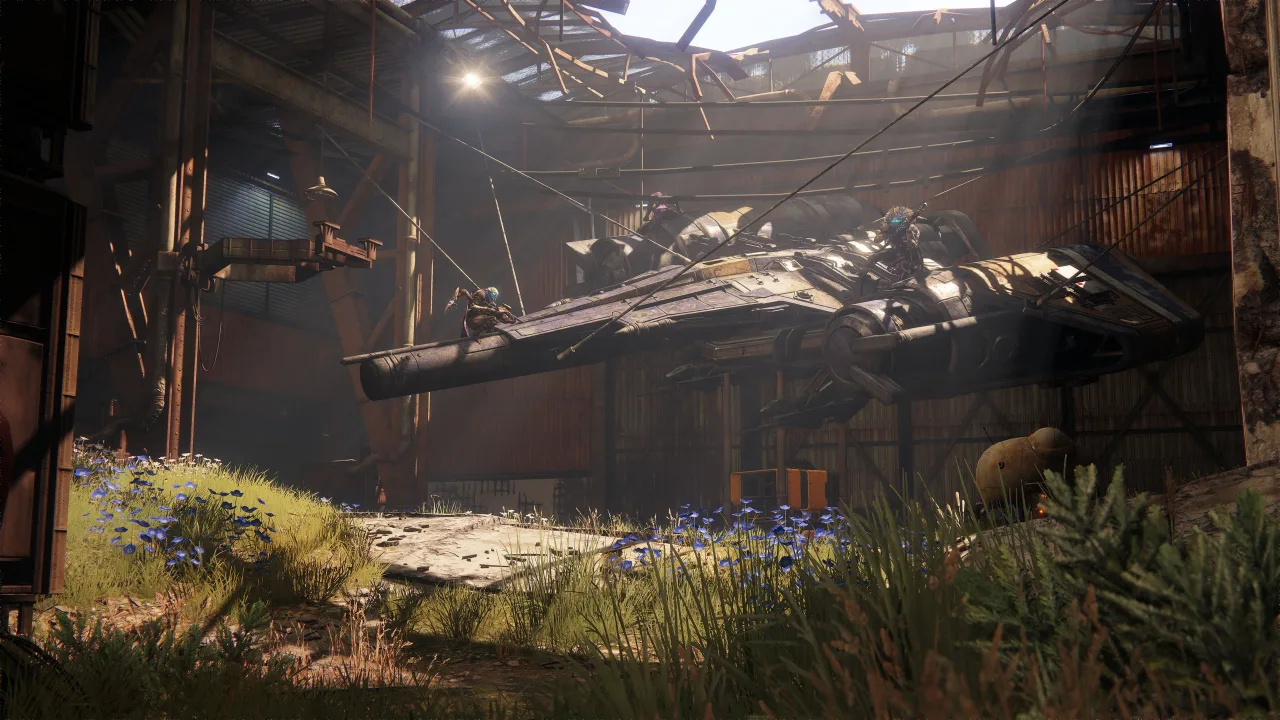 Jogador sentado, mãos na cabeça, ao lado de um console e pôster de Destiny 2 na parede