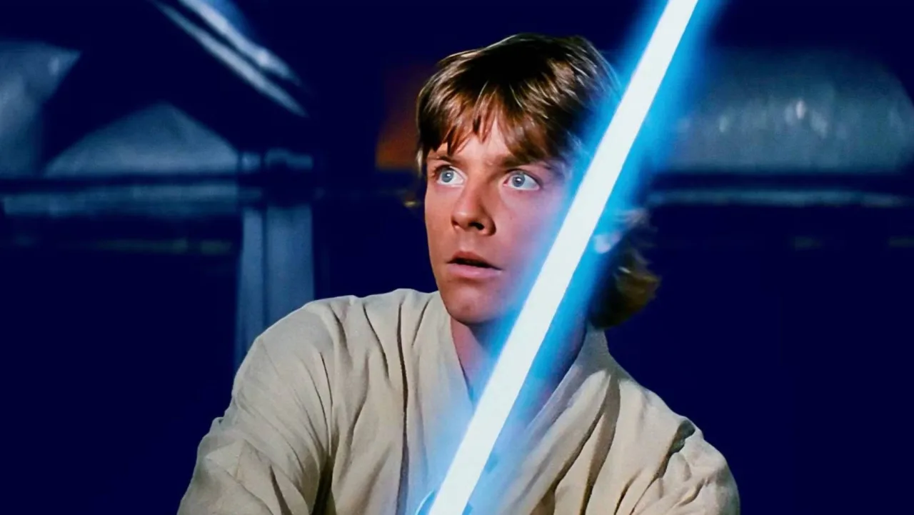 Carta Topps Star Wars 1977 de Luke Skywalker, com arte do personagem e selo SGC 9.5 em fundo preto