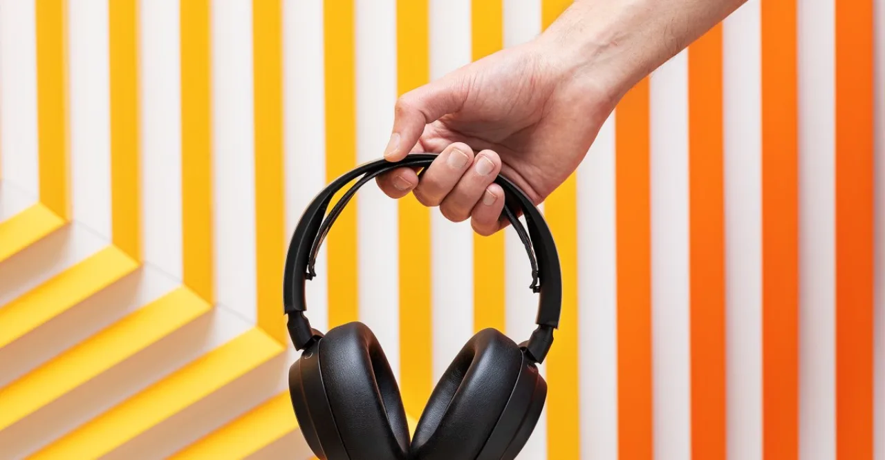 Um atleta correndo na esteira usando o headset Arctis Nova Pro Wireless, com o cabo desconectado e a tela do smartwatch exibindo batimentos