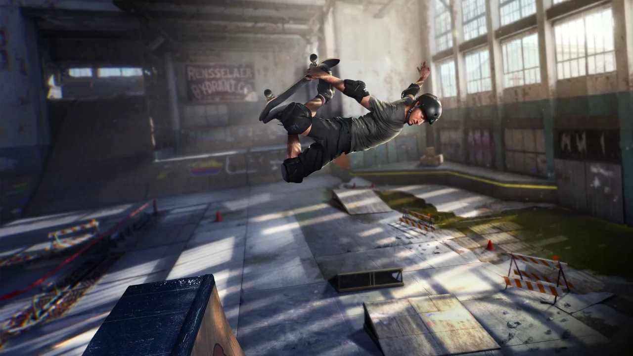 Jovem em roupa esportiva faz manobra de skate em pista indoor, segurando um controle Xbox ao lado