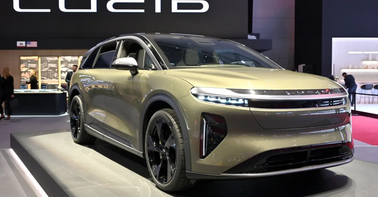 Pessoa correndo ao lado de um Lucid Motors estacionado, vestindo roupa esportiva e segurando uma garrafa de água
